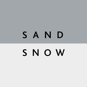 May include: A minimalist graphic design featuring the words "SAND" and "SNOW" in black, sans-serif font. The text is set against a two-tone background, with a gray upper section and a white lower section.