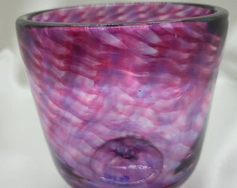 Beautiful deep decorative hand-blown glass bowl with purple and pink swirls