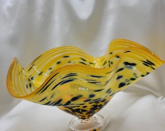 Leopard print hand-blown glass bowl yellow with blue spots.