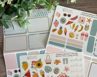 May include: A set of summer-themed stickers featuring a variety of designs, including fruits, flowers, and beach-related items. The stickers are printed on white paper with a pink and blue background. The text on the stickers reads "Clinging to Summer Monthly Kit Extra Decor (MK-057D)" and "weekend".