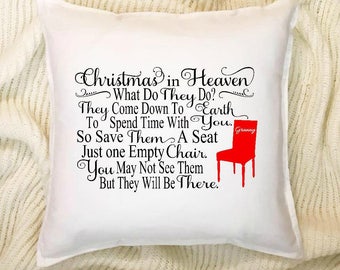 May include: White throw pillow with black text that reads "Christmas in Heaven What Do They Do? They Come Down To Earth To Spend Time With You. So Save Them A Seat Just One Empty Chair. You May Not See Them But They Will Be There." A red chair with the word "Granny" on the back is pictured in the bottom right corner.
