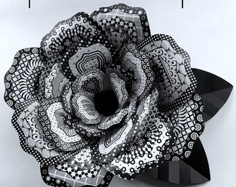 May include: A large, black and white paper rose with intricate patterns. The rose is 18 inches in diameter.