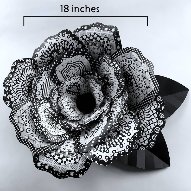 May include: A large, black and white paper rose with intricate patterns. The rose is 18 inches in diameter.