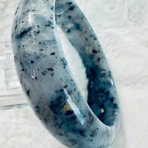 60mm Blue Jasper Bangle Bracelet, measures 18mm in width. The bangle has a beautiful heavenly blue tone!!! with mineral inclusions!!! lovely