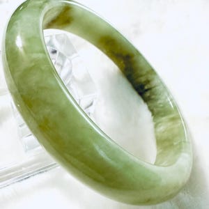 62.4mm Green Serpentine Jade Bangle Bracelet, measures 13.5mm in width.  The bangle has beautiful green luster!!! very soft green color!!!