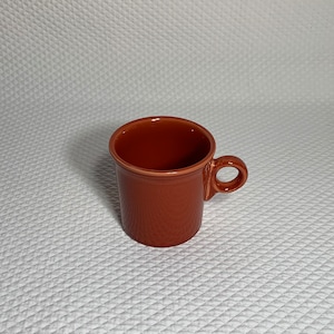Vintage terra cotta or rust colored Fiesta Ware mug, Made in USA.