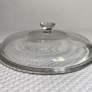 May include: A set of three ceramic mugs with a speckled, matte finish. Each mug features a different color: light blue, cream, and gray. The mugs have a simple, modern design with a rounded shape and a comfortable handle.