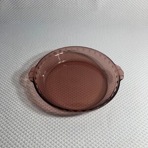 Pyrex 229 pie dish. Marked: 24cm, For oven and microwave, No Stovetop No Broiler, Corning NY USA 2, in cranberry glass