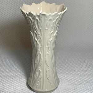 May include: A set of three ceramic mugs with a speckled, matte finish. The mugs are in shades of cream, light gray, and dark gray. Each mug has a simple, minimalist design, perfect for coffee or tea.