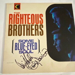 May include: A vintage vinyl record album cover featuring a photo of The Righteous Brothers, a musical duo. The album title is "Some Blue-Eyed Soul" and the cover is signed by the band members.