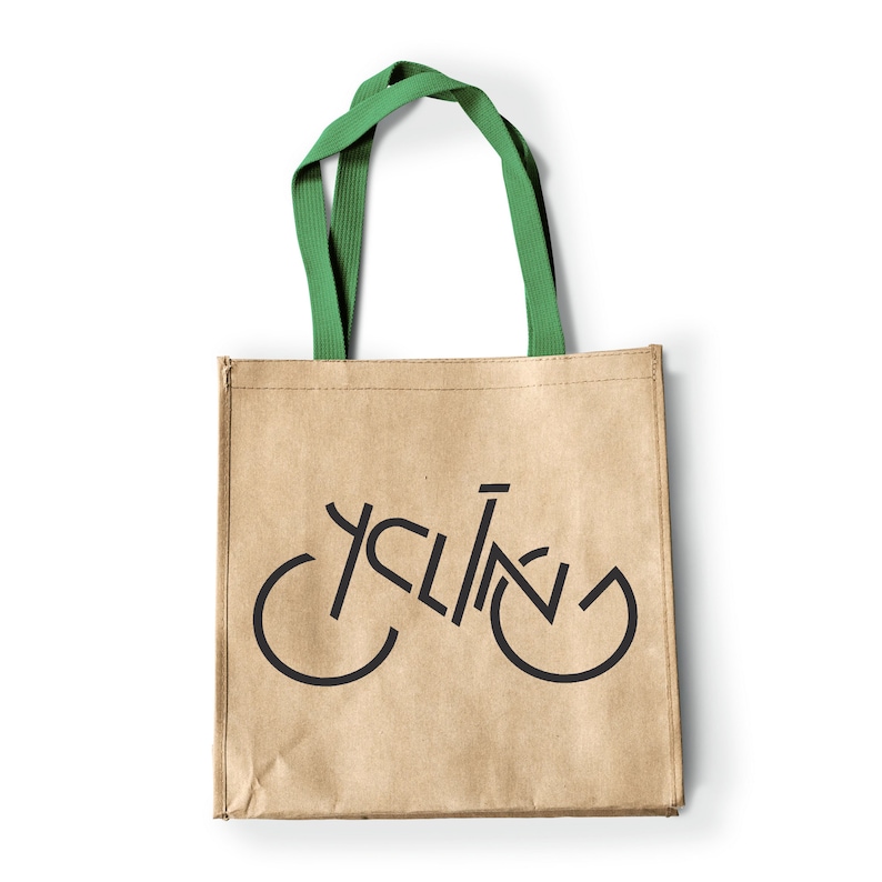 May include: A brown paper tote bag with green handles. The bag has a black graphic of a bicycle with the word "cycling" incorporated into the design.
