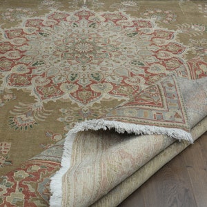 May include: A brown and beige rug with a floral pattern. The rug is folded in half and the underside is visible.