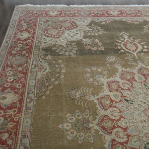 May include: A large, intricately patterned rug with a brown background and red, white, and blue accents. The rug has a floral design with a central medallion.