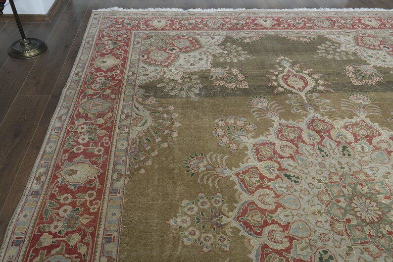 May include: A large, intricately patterned rug with a brown background and red, white, and blue accents. The rug has a floral design with a central medallion.