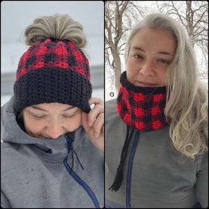 May include: A red and black buffalo check crochet hat with a black brim and a matching neck warmer. The hat has a messy bun opening. The neck warmer has black drawstrings with tassels. Both items are handmade.
