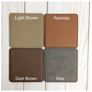May include: Four square leather coasters in different colors: light brown, rawhide, dark brown, and gray. Each coaster has a stitched edge.