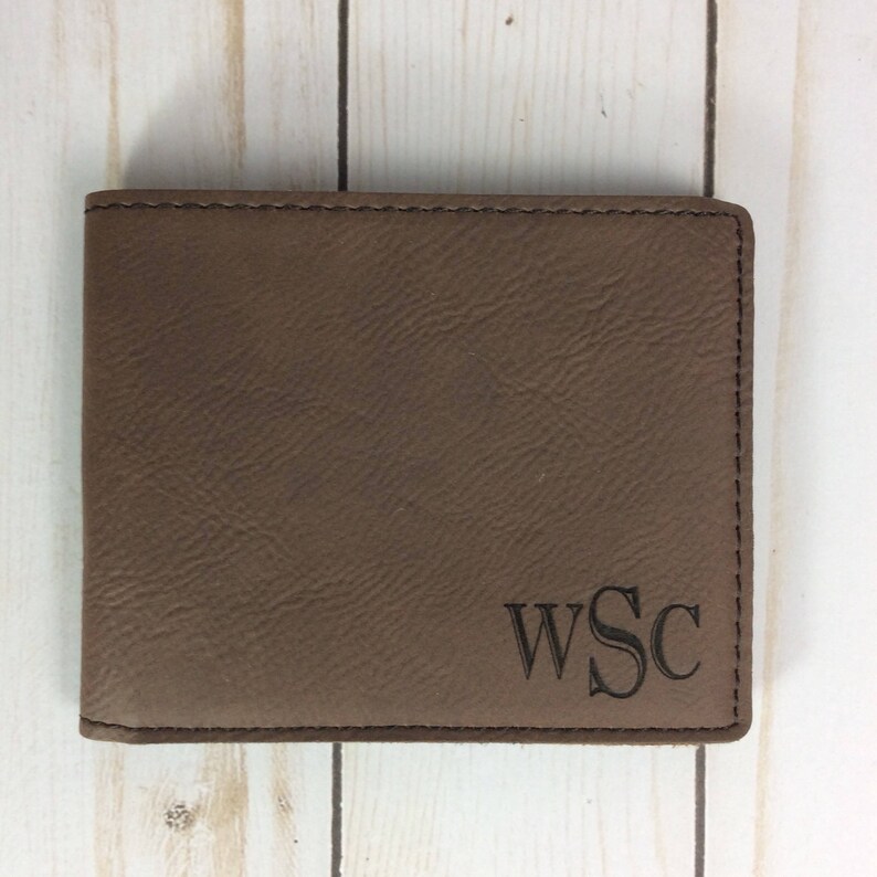 May include: Brown leather wallet with a monogram of the initials WSC.