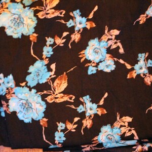 Beautiful dark navy fabric with a delicate floral turquoise print