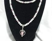 Glass pearl double stranded necklace with lilac contrasts and heart pendant.