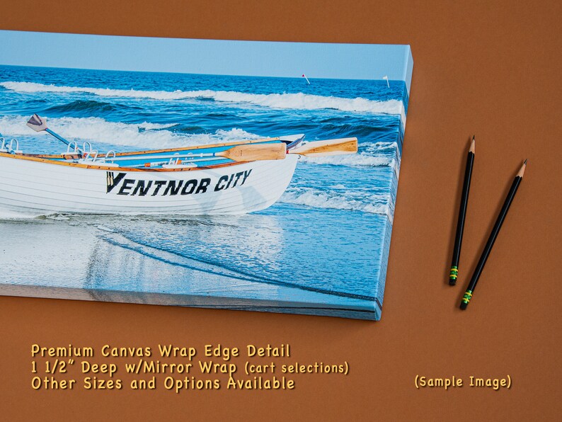 May include: A canvas print depicting a white rowboat on a beach, with the text "VENTNOR CITY". The background shows ocean waves. Two pencils are positioned on the right side of the image.