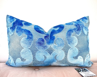 May include: A blue and light blue patterned throw pillow with a velvet texture.