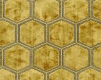 May include: A gold and brown patterned fabric with a honeycomb design. The fabric has a subtle sheen and a textured surface.