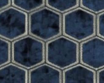 May include: A blue and white patterned fabric with a honeycomb design. The fabric has a textured, velvety feel.
