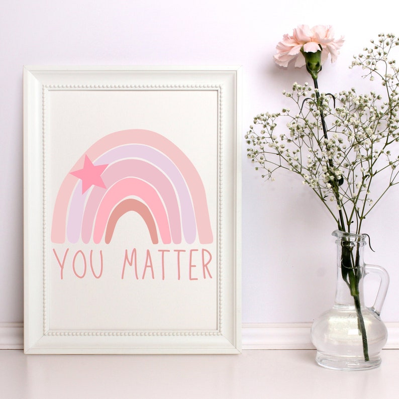 May include: A white framed print featuring a pink and purple rainbow with a pink star. The text "You Matter" is written beneath the rainbow.