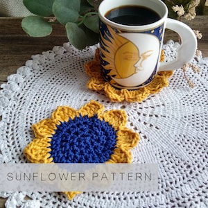 May include: Two crocheted sunflower coasters in yellow and blue, with a white crocheted doily and a mug with a sun and moon design on top of one of the coasters. The text "SUNFLOWER PATTERN" is at the bottom of the image.