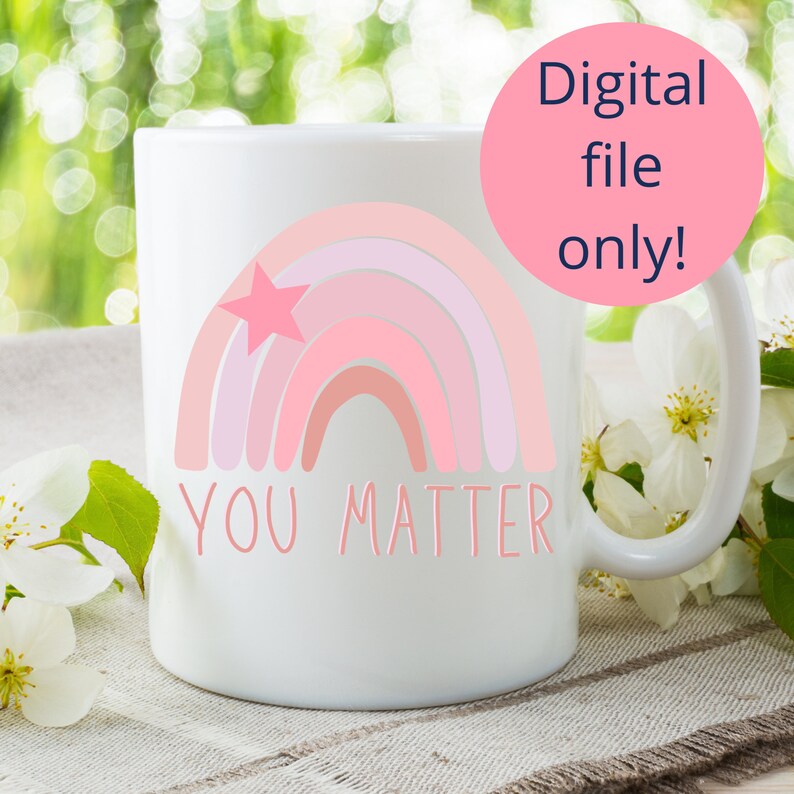 May include: White ceramic mug featuring a pink rainbow and a star design. The text "YOU MATTER" is printed below the rainbow.