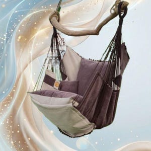 May include: A hanging hammock chair featuring a combination of dark brown and beige fabric panels. The chair is suspended from a thick wooden spreader bar by dark brown ropes and includes a matching dark brown cushion for back support.