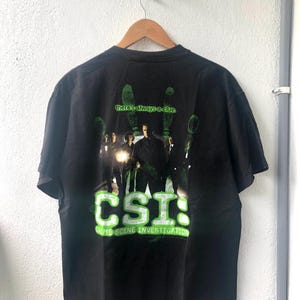 Camiseta promocional vintage original de principios de los años 2000 de CSI: Crime Scene Investigation “Siempre hay una pista” del drama criminal estadounidense