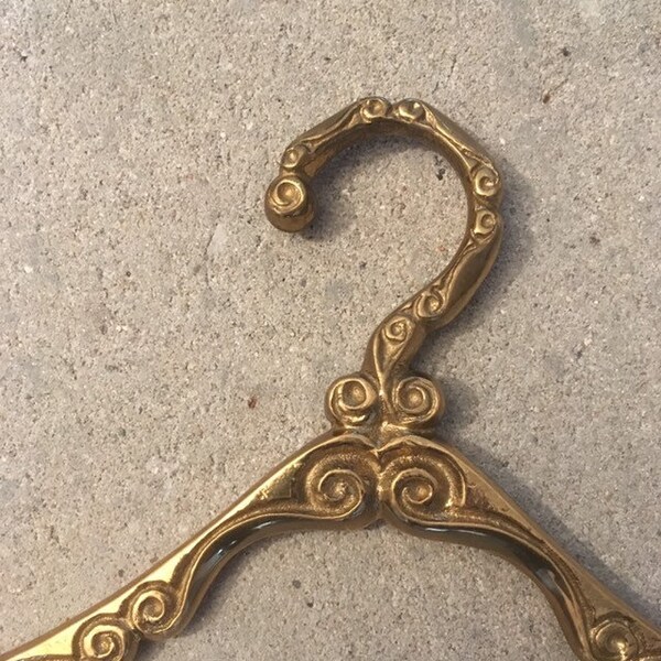 Antique brass clothes hanger