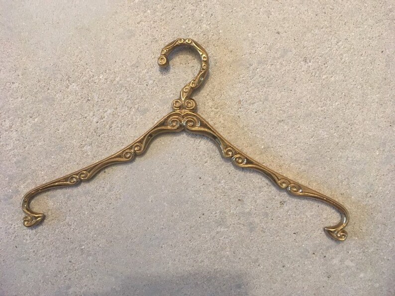 Antique brass clothes hanger