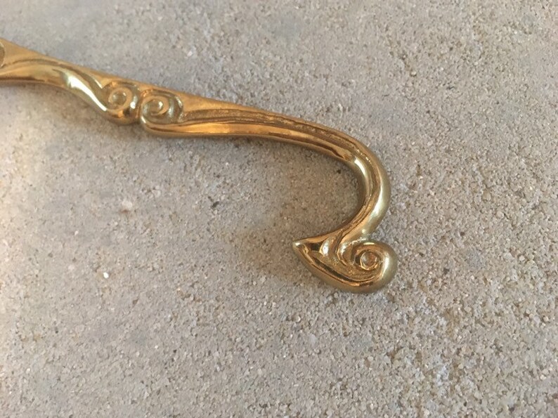 Antique brass clothes hanger