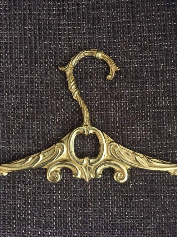 Antique brass clothes hanger