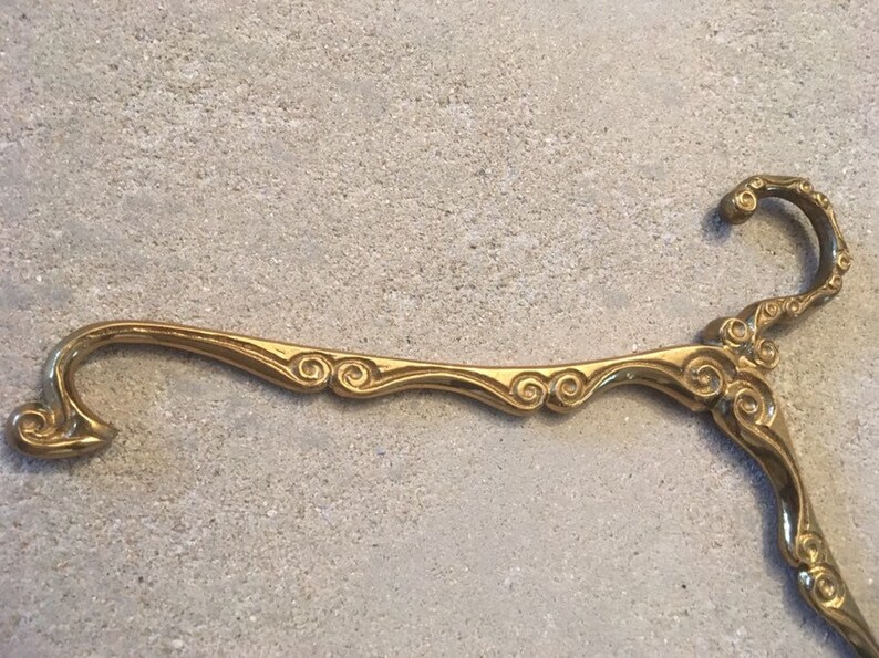 Antique brass clothes hanger