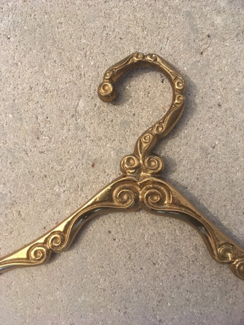 Antique brass clothes hanger