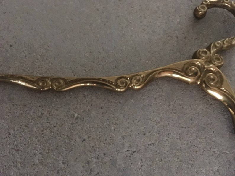 Antique brass clothes hanger