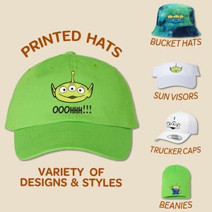 May include: A variety of printed hats featuring a green alien character with the text "OOOHHH!!!". The hats include bucket hats, sun visors, trucker caps, and beanies.
