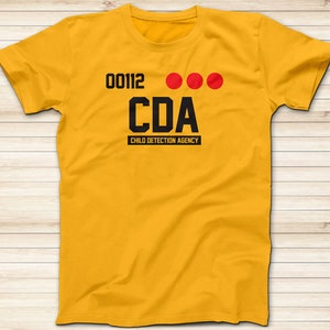May include: Yellow t-shirt with black text that reads "00112 CDA CHILD DETECTION AGENCY".