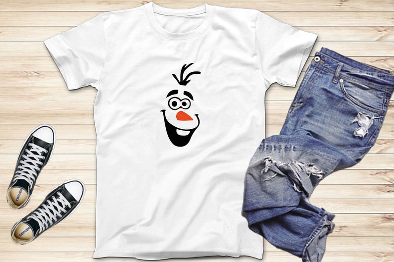 May include: White t-shirt with a black and orange cartoon face of Olaf from the movie Frozen.
