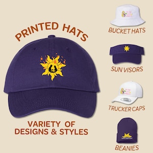 May include: A variety of printed hats in different styles, including bucket hats, sun visors, trucker caps, and beanies. The hats feature a variety of designs, including a sun with a silhouette of two people, a cartoon princess, and the text "I'm the Little Mermaid".
