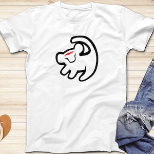 May include: White t-shirt with a black outline of Simba from The Lion King, with a red heart on his head.