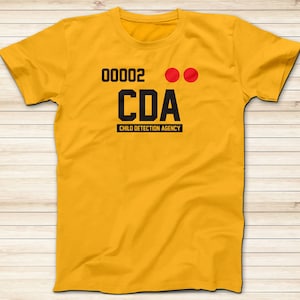 May include: A yellow t-shirt with black text that reads "00002 CDA CHILD DETECTION AGENCY" and two red dots.