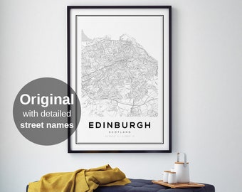 May include: Black and white map print of Edinburgh, Scotland, in a black frame hanging on a white wall. A yellow throw blanket is draped over a dark blue bench with gold legs. There are two white ceramic mugs and a white ceramic teapot with a silver handle on a wooden tray on the bench.