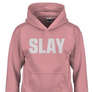 May include: A pink hooded sweatshirt with the word "SLAY" printed in white on the front.