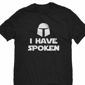 May include: Black t-shirt with a white graphic of a Mandalorian helmet and the text "I HAVE SPOKEN".