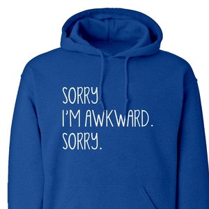 May include: A royal blue hooded sweatshirt with the text "SORRY I'M AWKWARD. SORRY." printed in white.