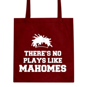 May include: A maroon tote bag with a white graphic of a paint splatter and the text "There's No Plays Like Mahomes".